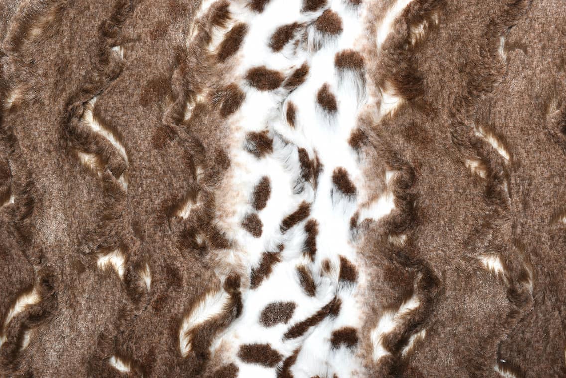Close up of brown spotted style minky blanket.